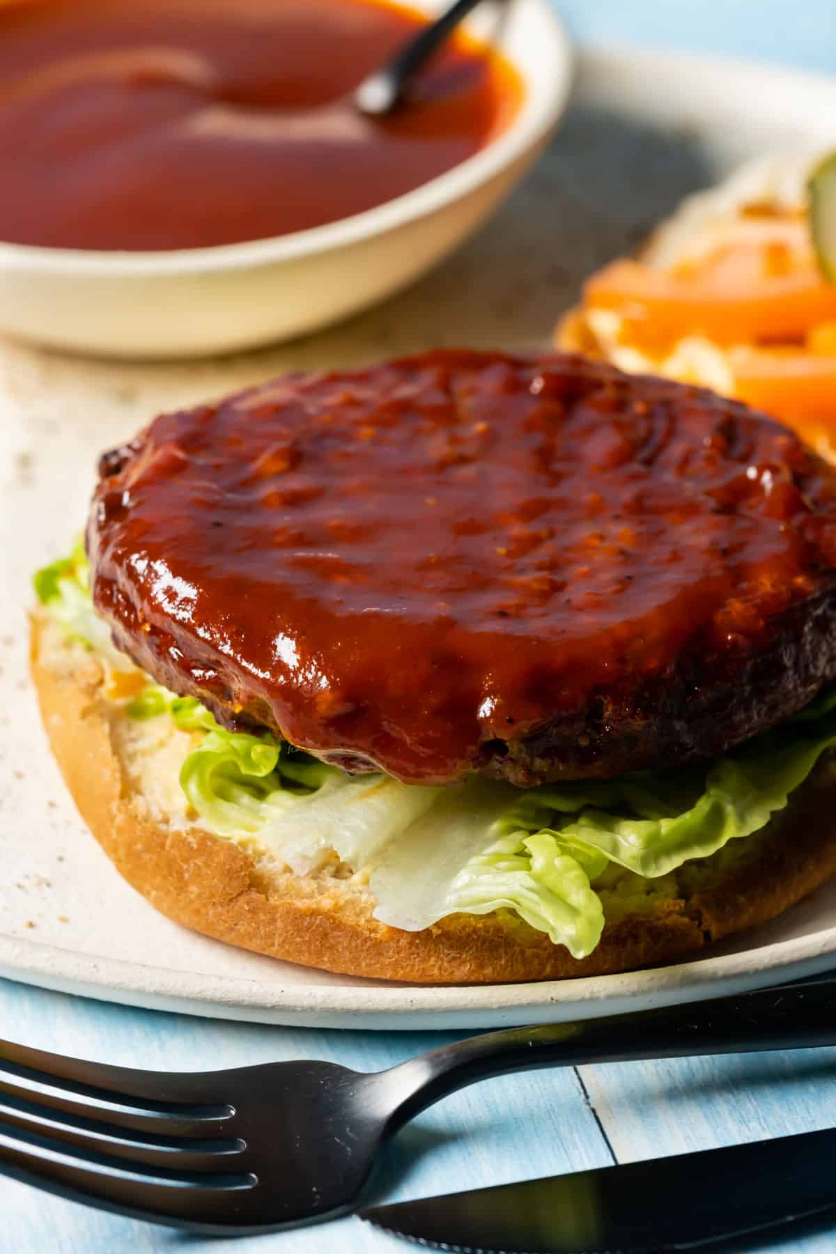 Veggie burger topped with vegan bbq sauce.