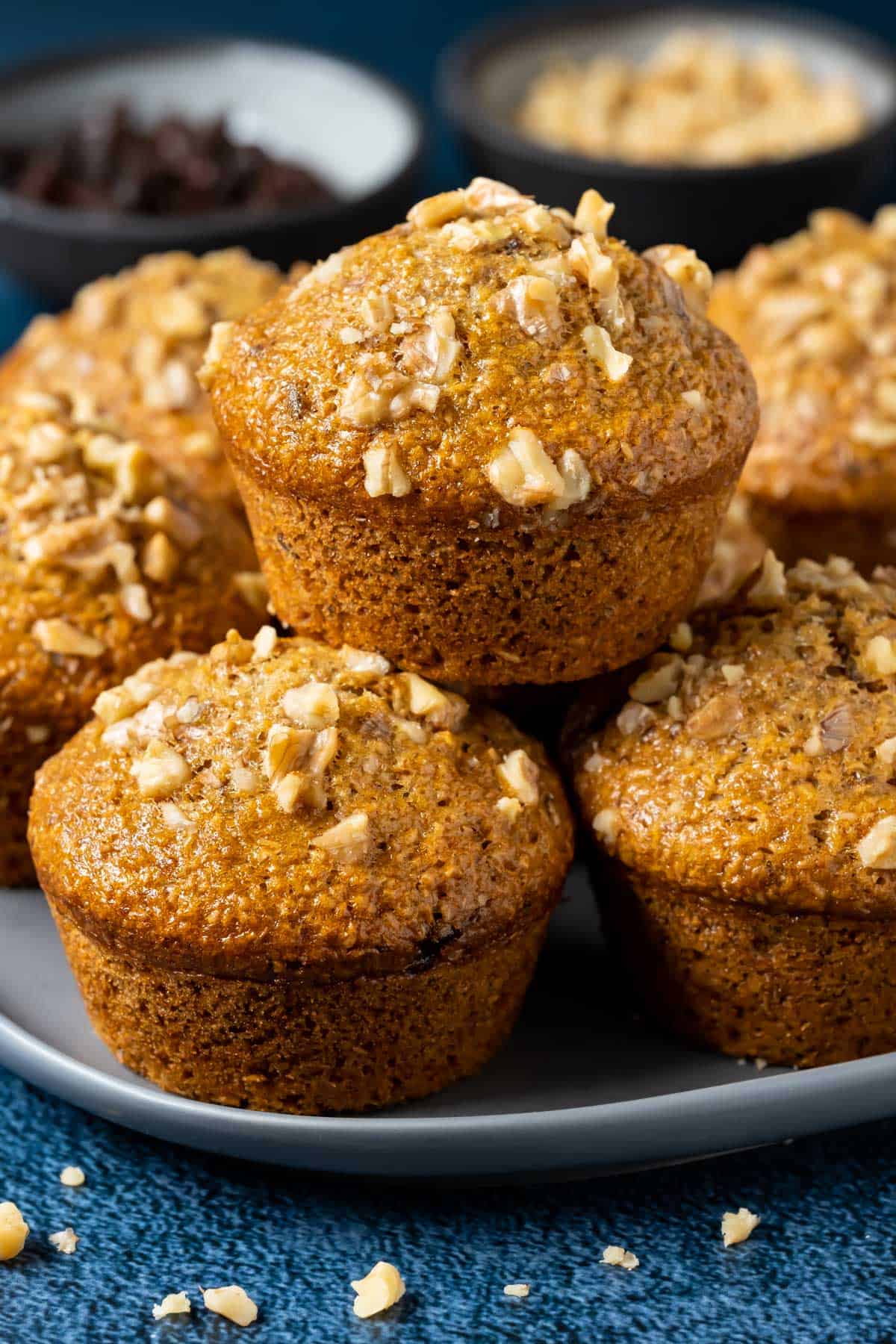 Stack of vegan bran muffins on a plate.