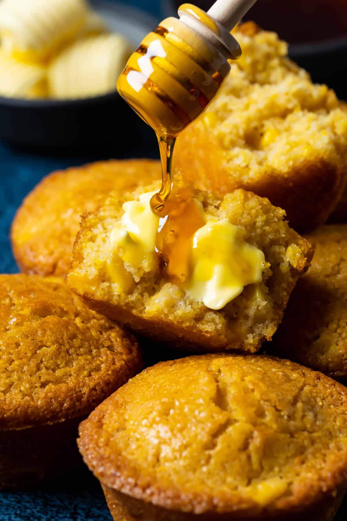 Syrup drizzling over a buttered cornbread muffin