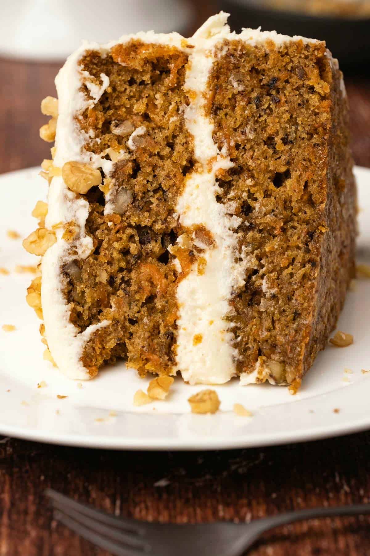 Slice of carrot cake on a white plate.
