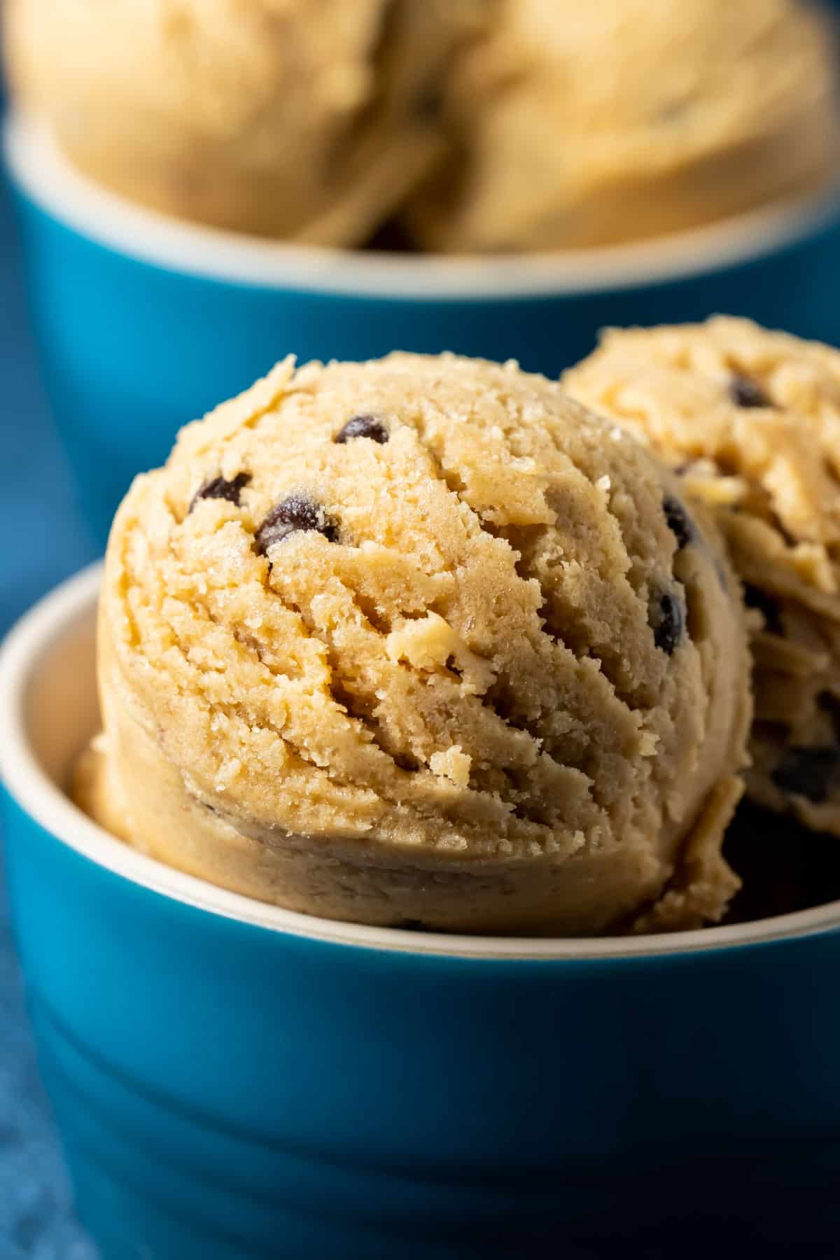 Vegan cookie dough scoops in a blue bowl.