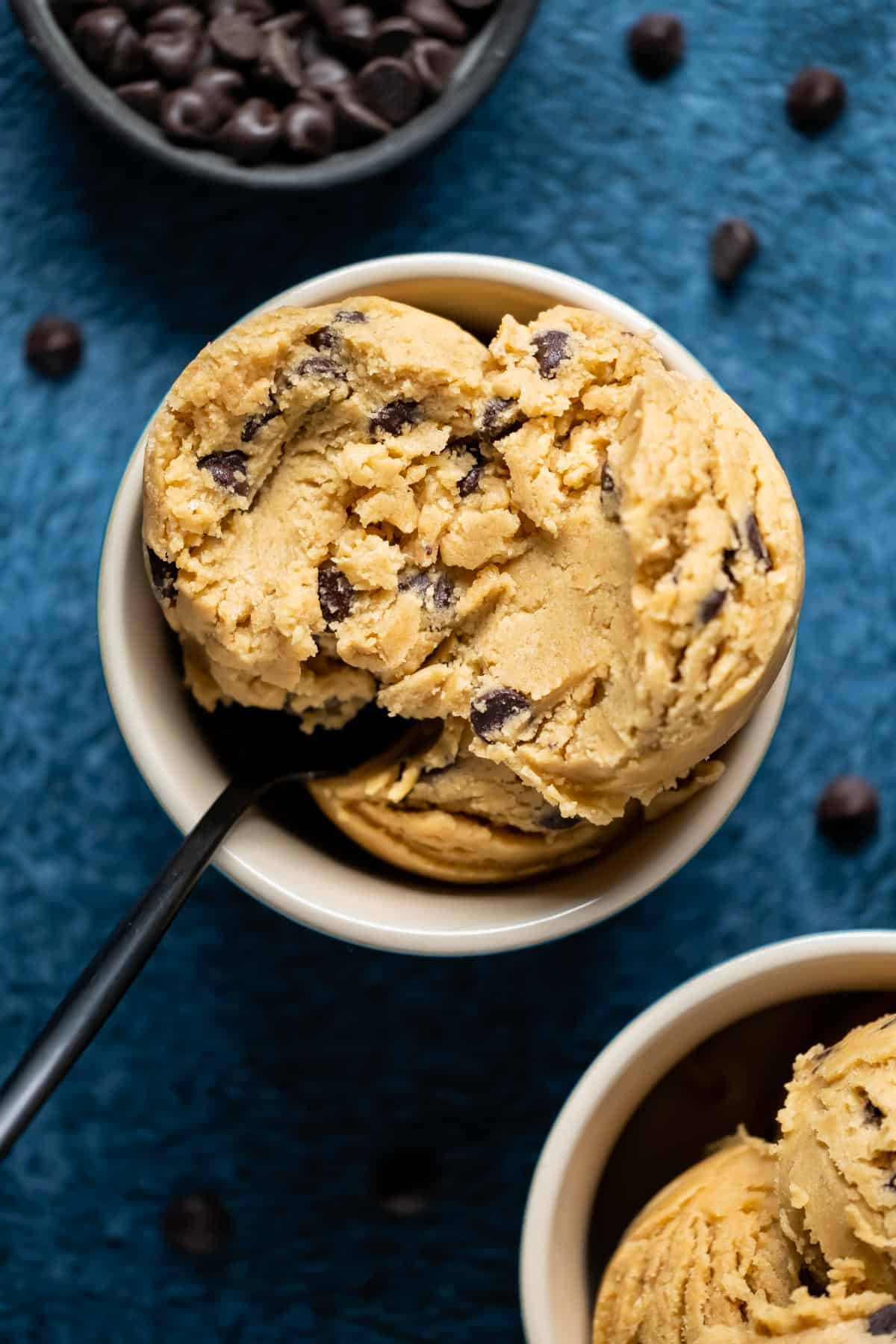 Cookie dough scoops in a bowl with a spoon.