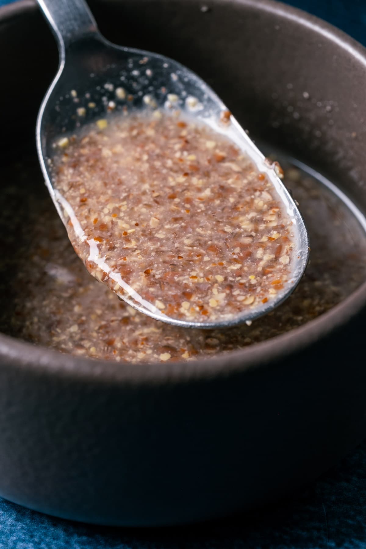 Flax egg in a bowl with a spoon.