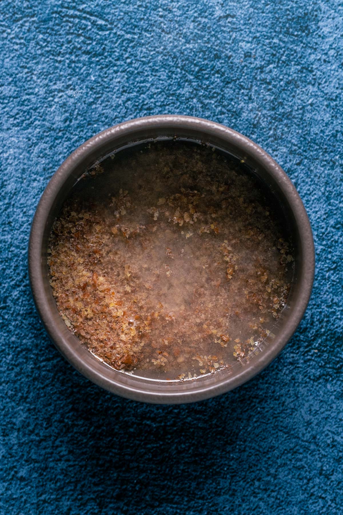 Photo of ground flaxseeds and hot water mixed together in a bowl.