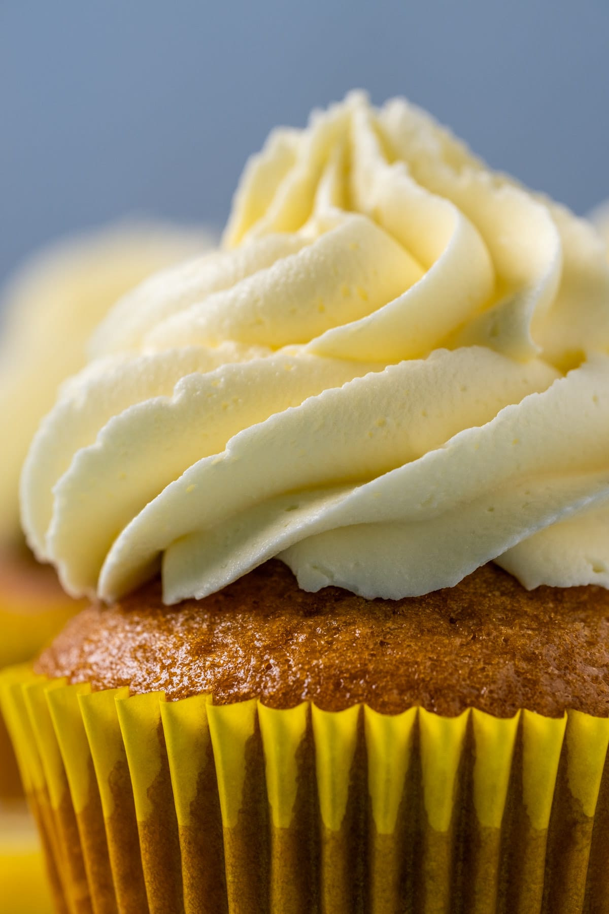 Cupcake topped with lemon buttercream frosting.