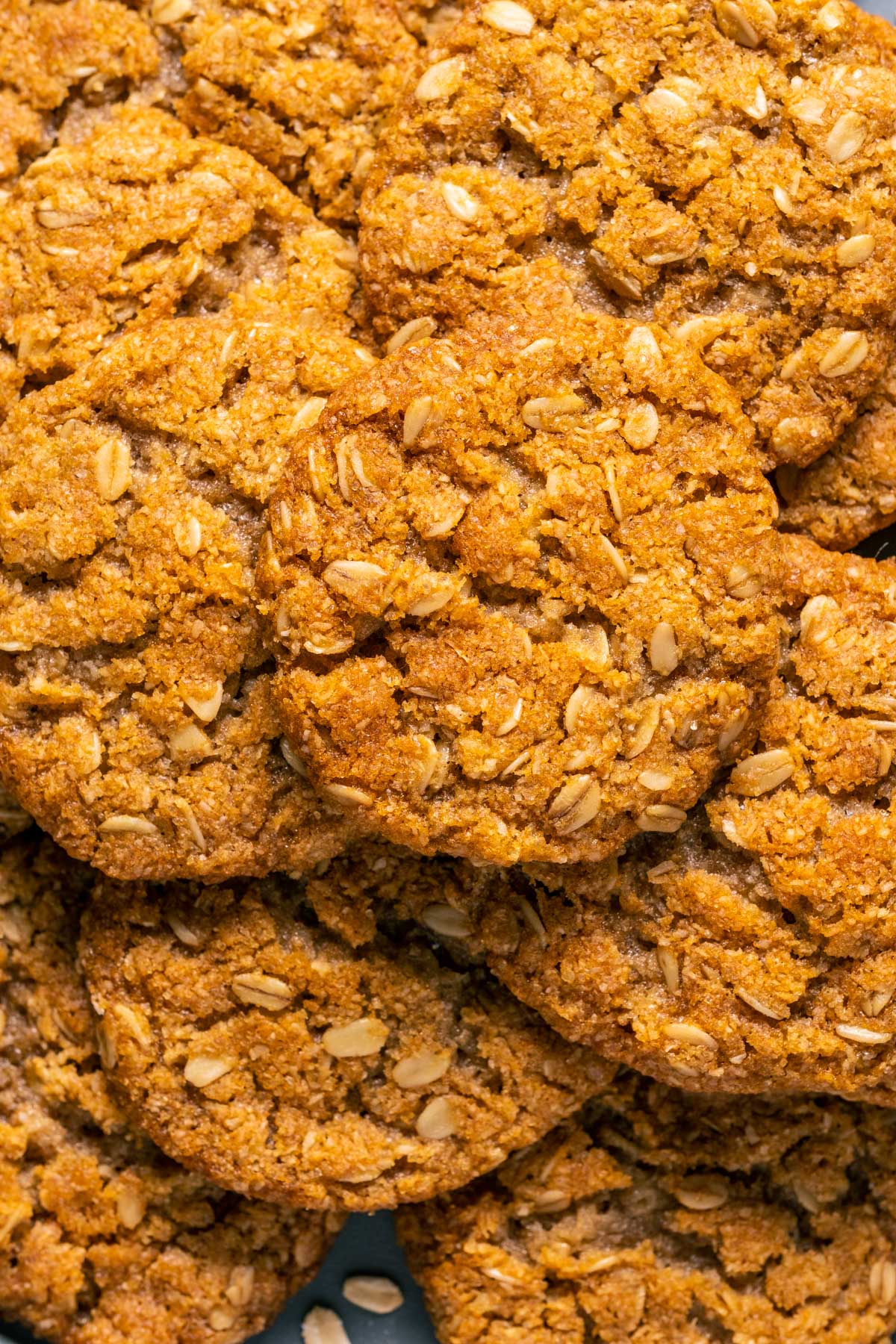 Close up of vegan oatmeal cookies stacked up on a plate.