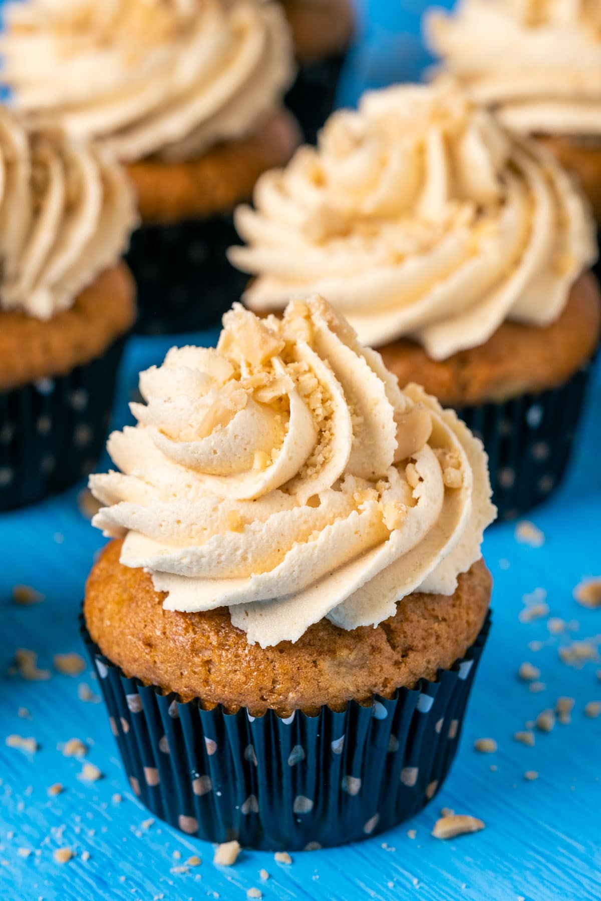 Vegan banana cupcakes topped with peanut butter frosting and crushed peanuts. 