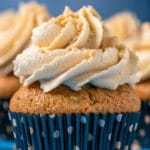 Banana cupcake topped with peanut butter frosting and crushed peanuts.