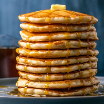 Stack of vegan buttermilk pancakes on a blue plate.