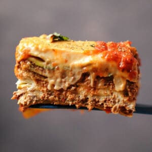Slice of vegan lasagna on a white plate.