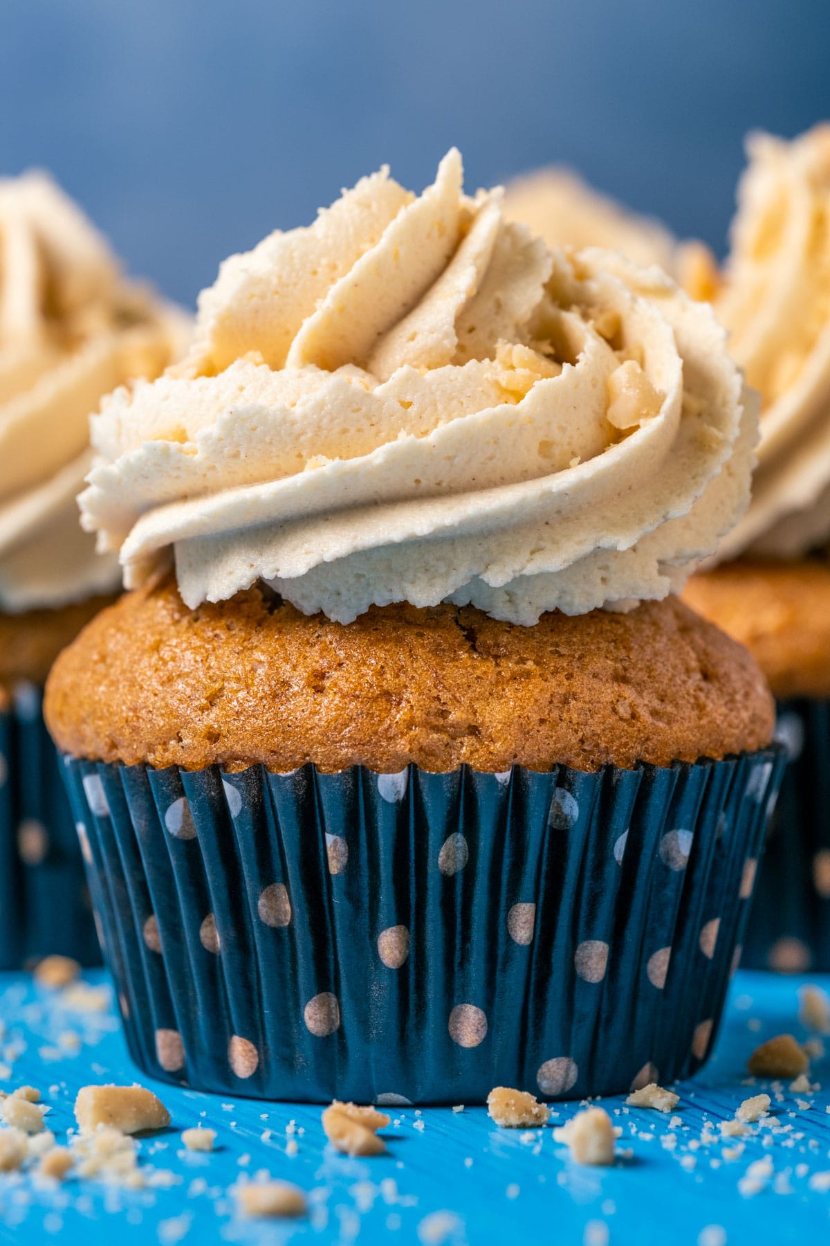 Cupcake topped with vegan peanut butter frosting and crushed peanuts.