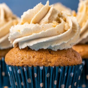 Cupcake topped with peanut butter frosting and crushed peanuts.