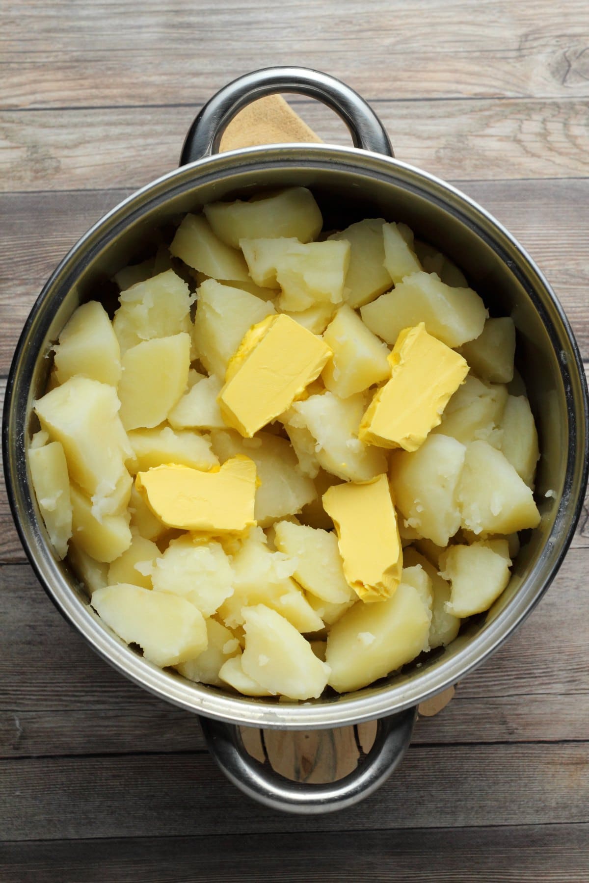 Vegan potatoes and vegan butter in a pot. 