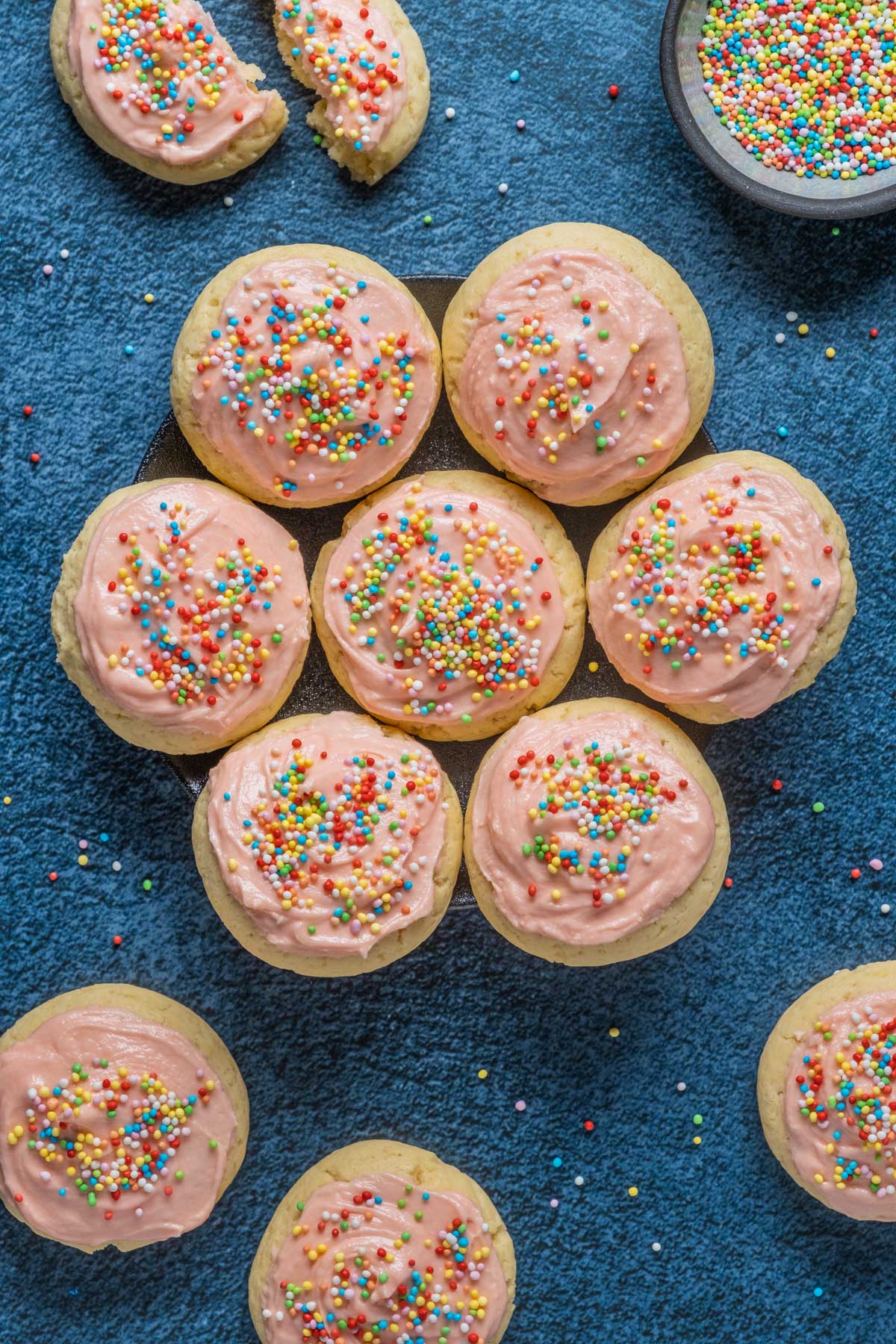 Vegan frosted sugar cookies on a plate.