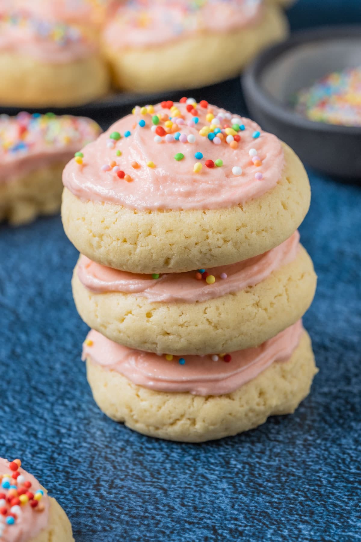 Stack of three frosted sugar cookies.