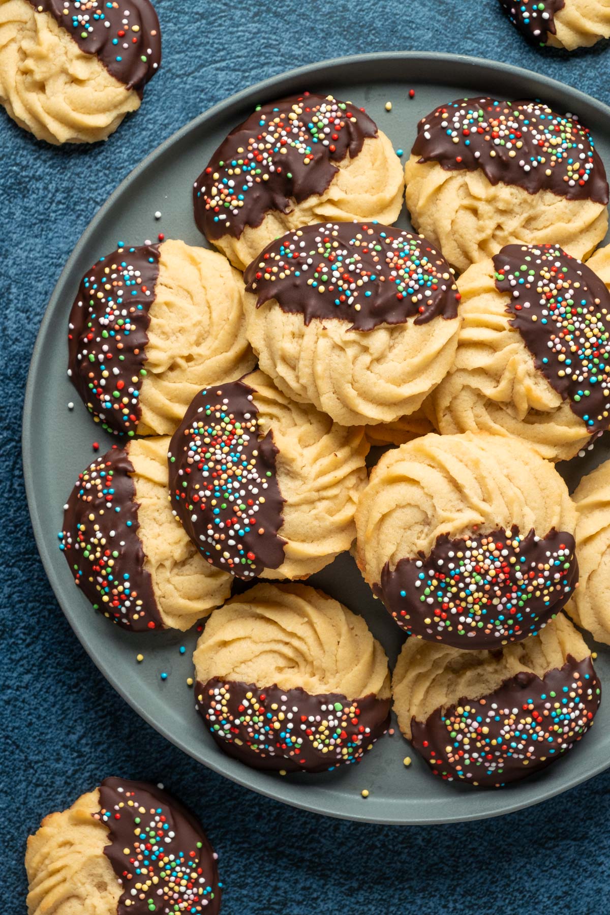 Vegan butter cookies stacked up on a plate. 