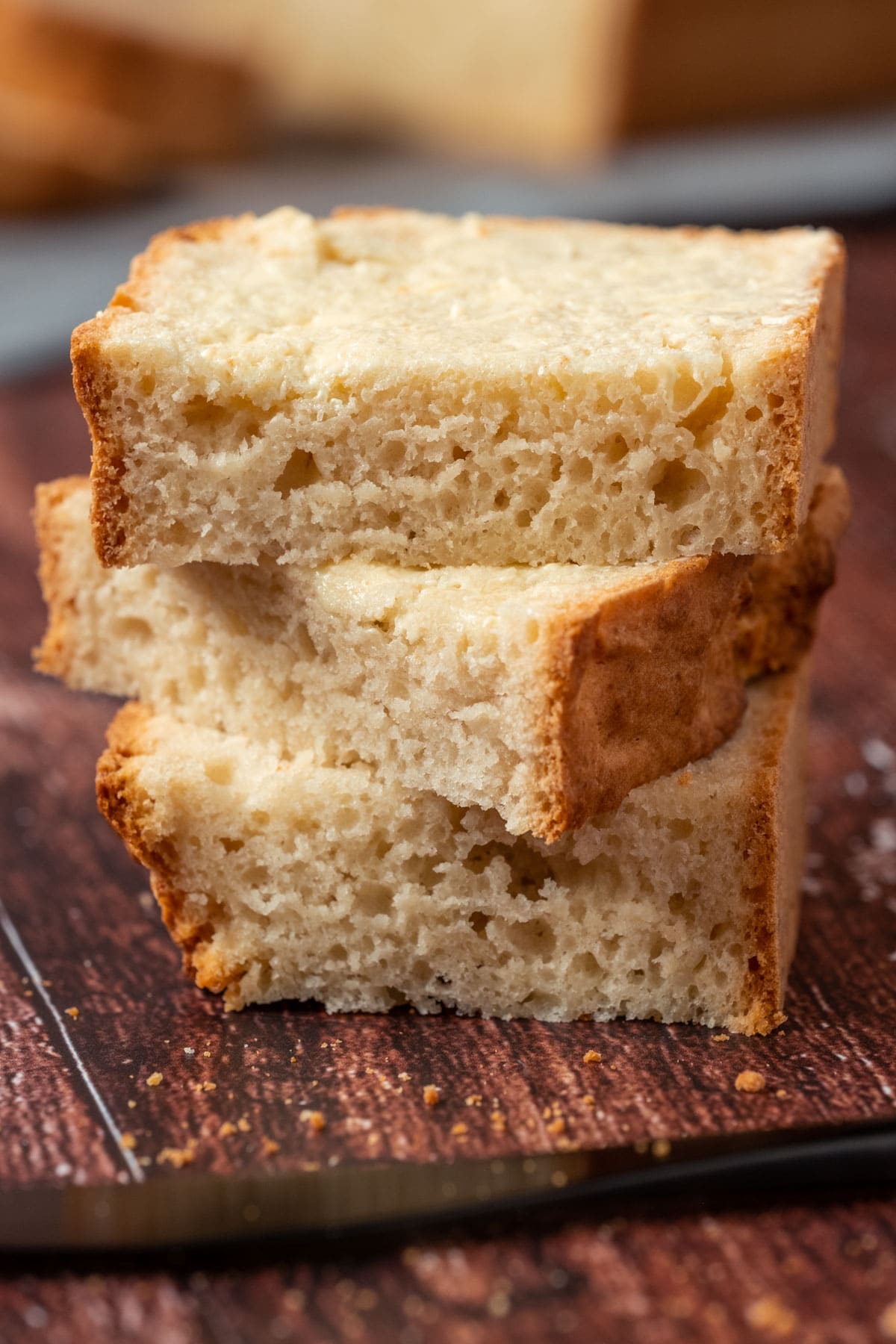 Buttered slices of vegan beer bread in a stack.