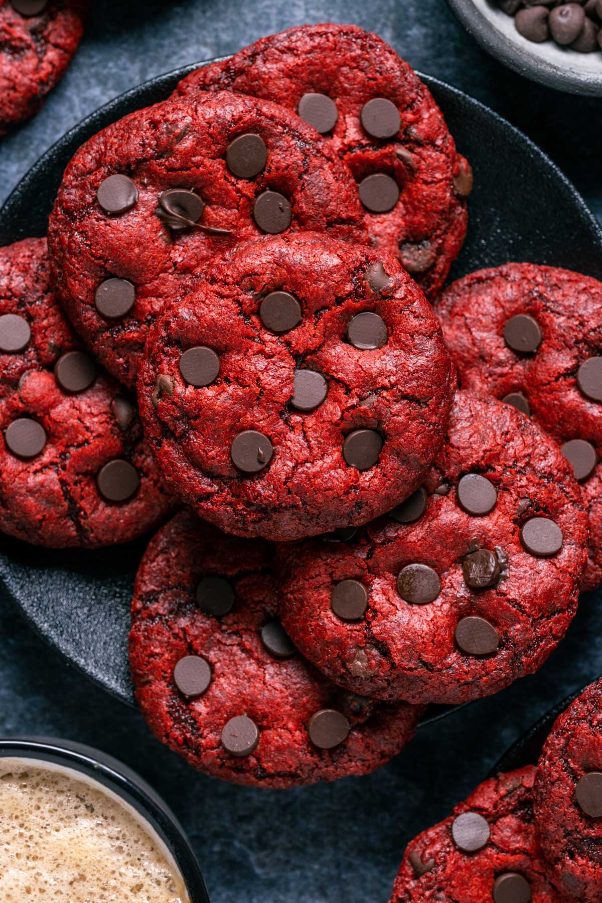 Vegan red velvet cookies stacked up on a plate.