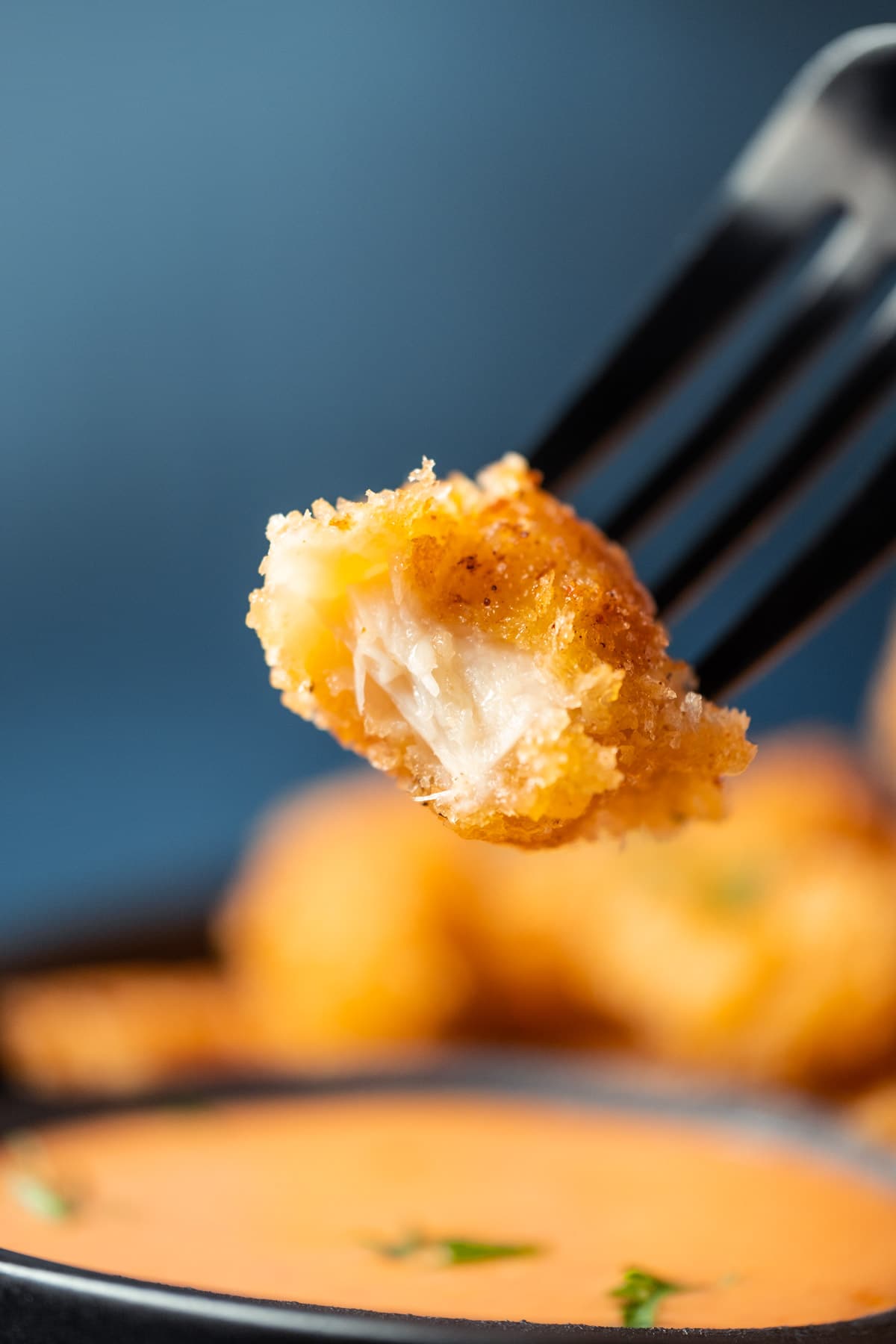 Vegan shrimp on a fork with a bite removed.