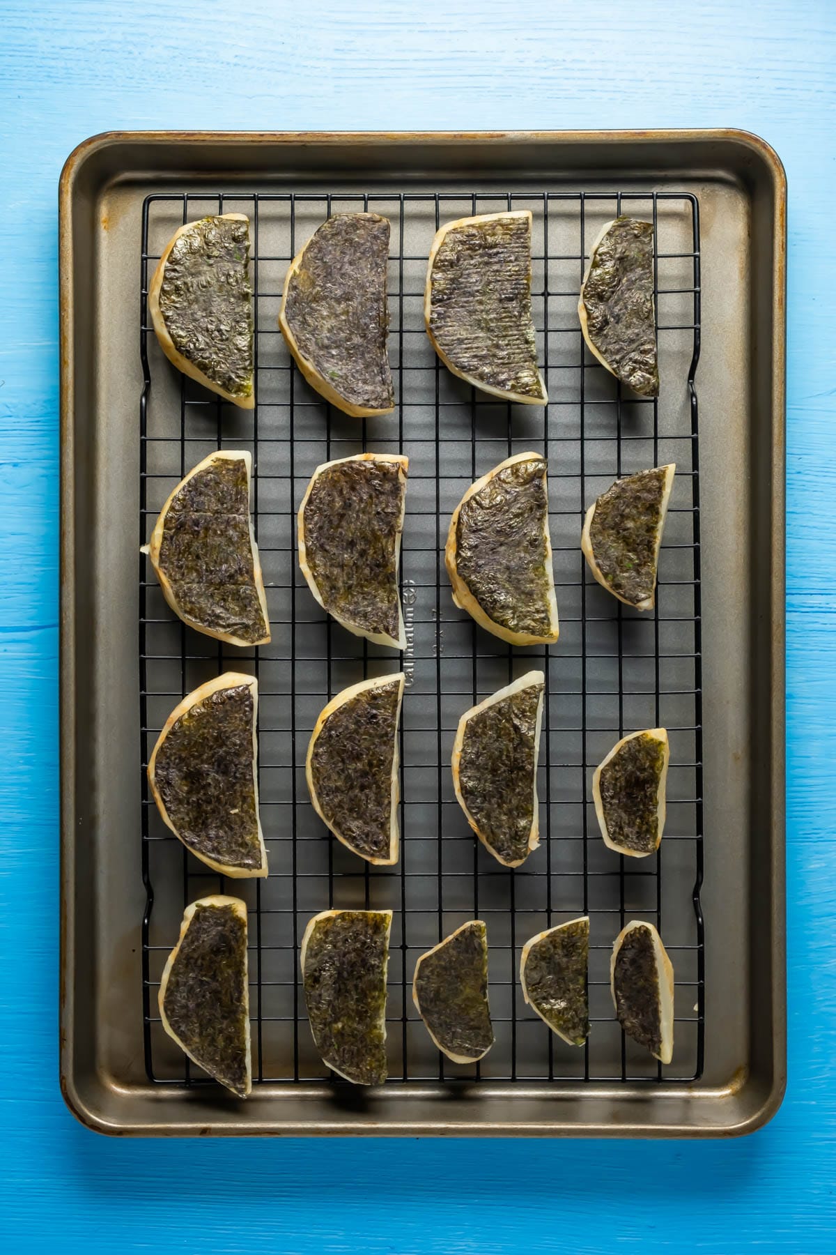 Celeriac pieces topped with nori on a wire rack.