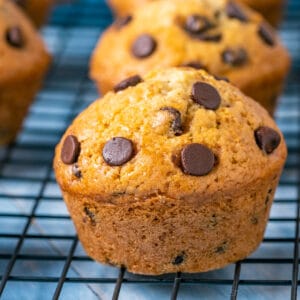 Vegan chocolate chip muffins on a wire cooling rack.