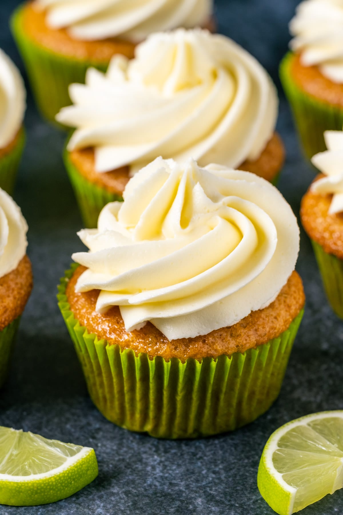 Vegan key lime cupcakes with slices of fresh lime. 