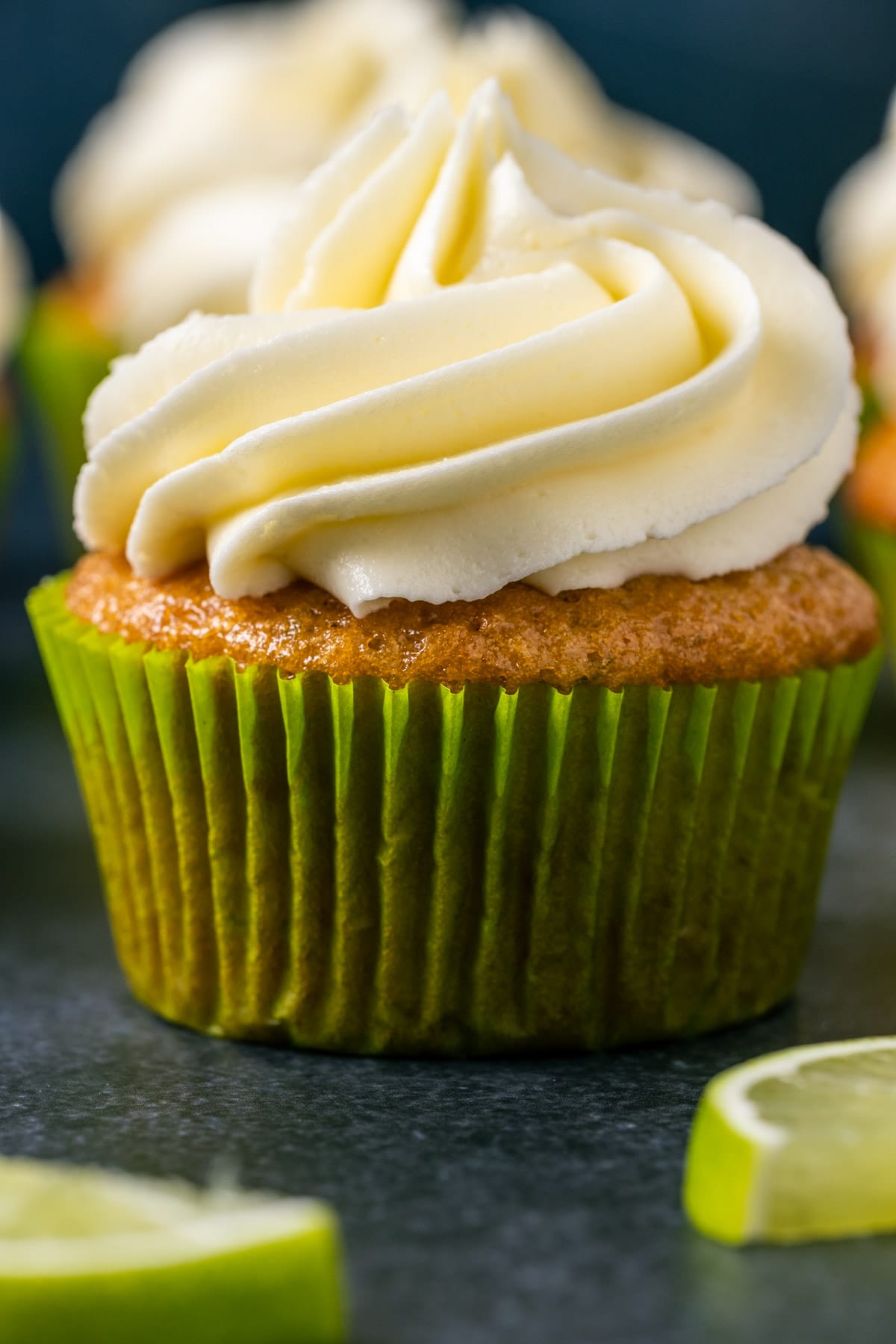 Vegan key lime cupcakes with slices of fresh lime.