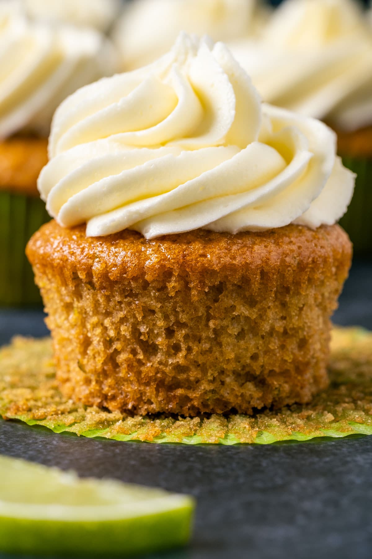 Vegan key lime cupcake with the liner pulled down.