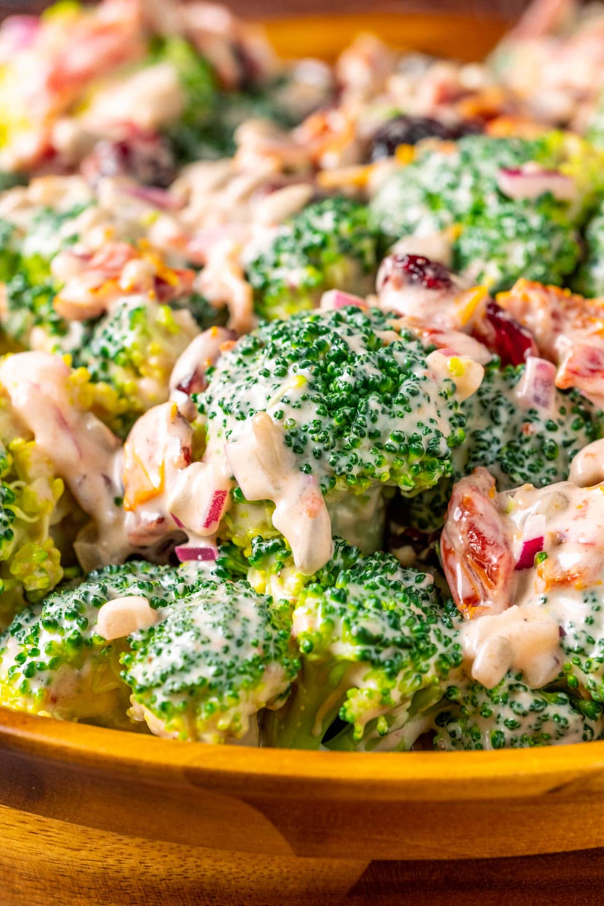 Vegan broccoli salad in a wooden salad bowl.