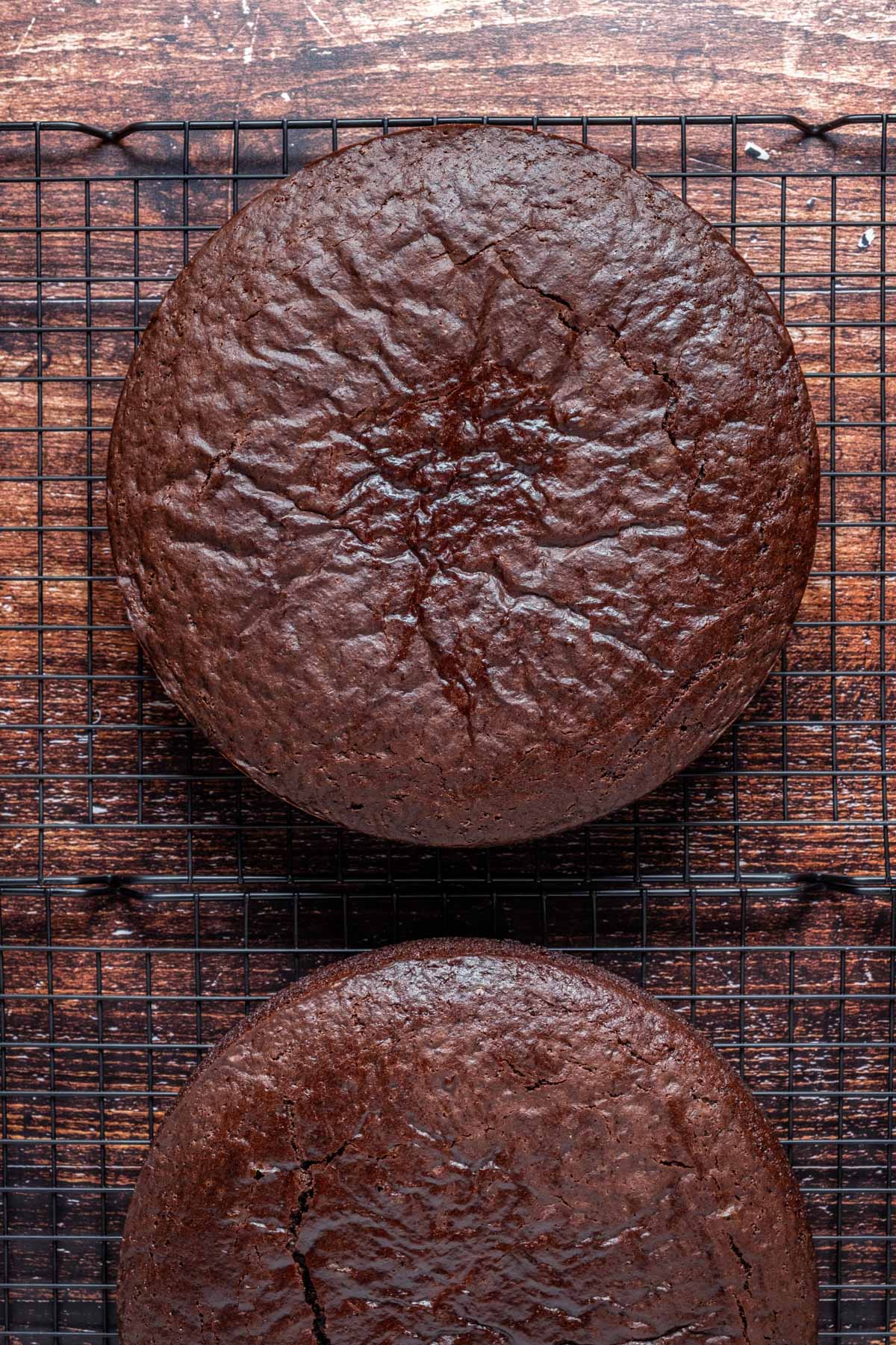Vegan chocolate fudge cakes cooling on a wire cooling rack.