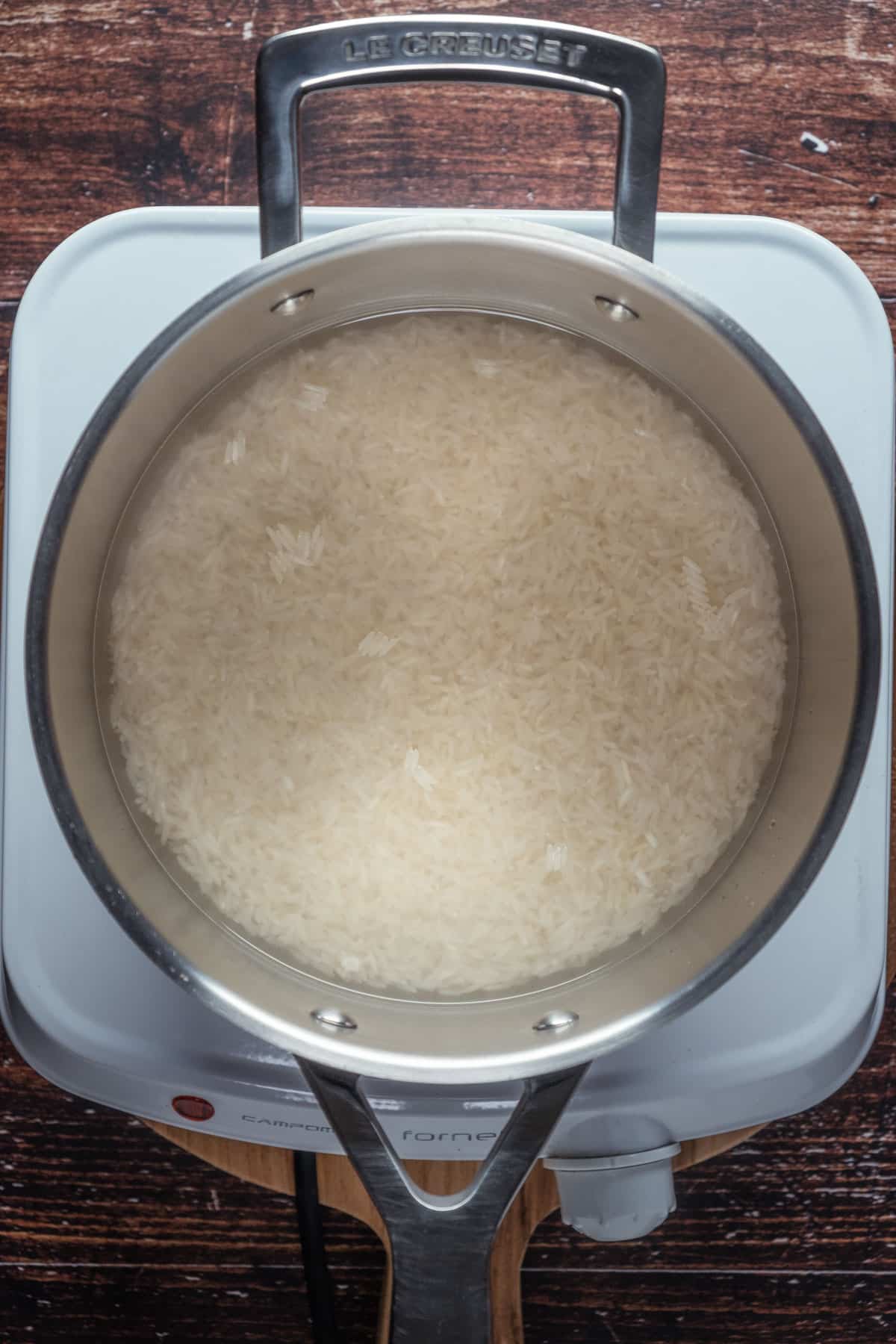 Heating basmati rice and water in a pot.