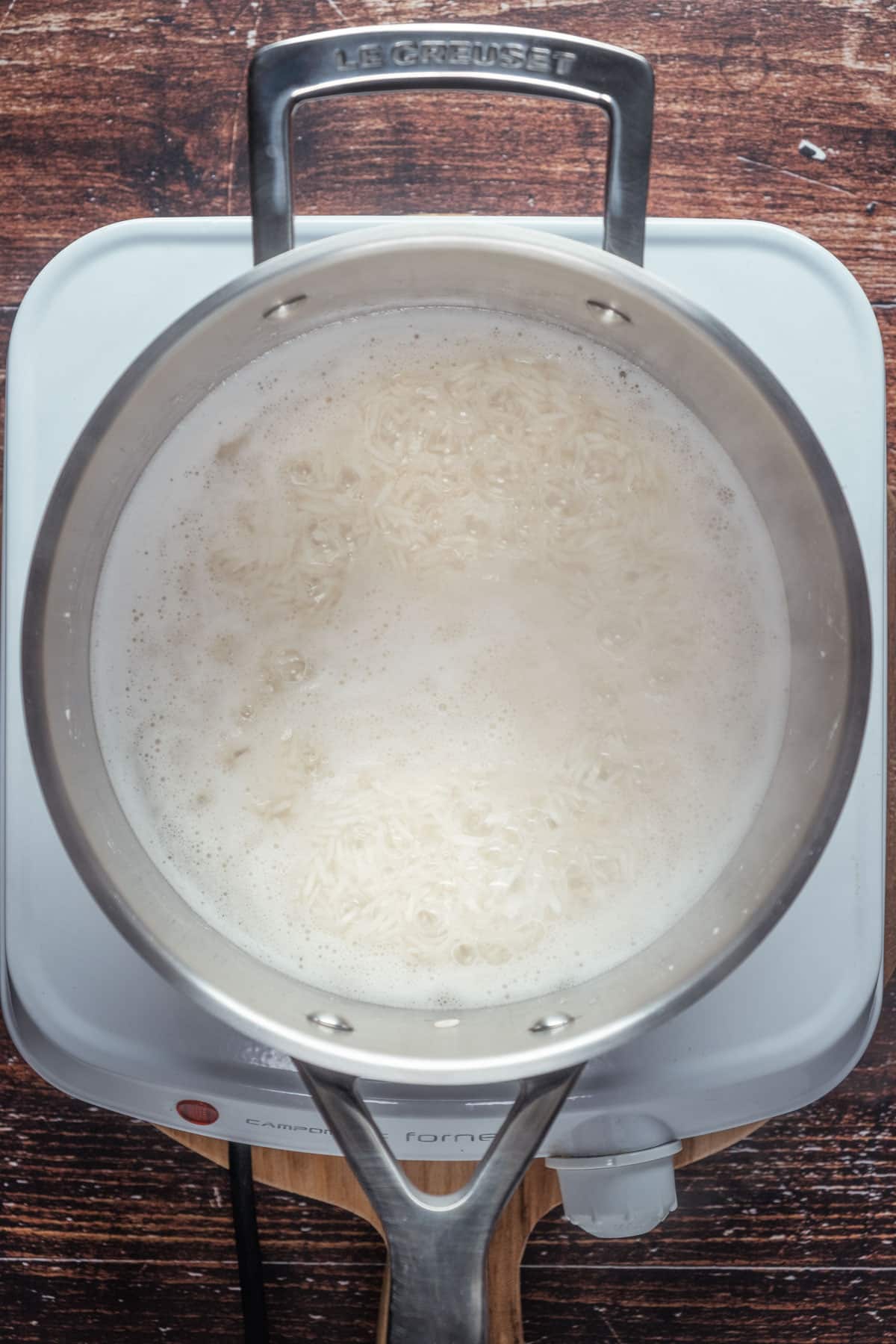 Basmati rice and water brought to a boil in a pot.