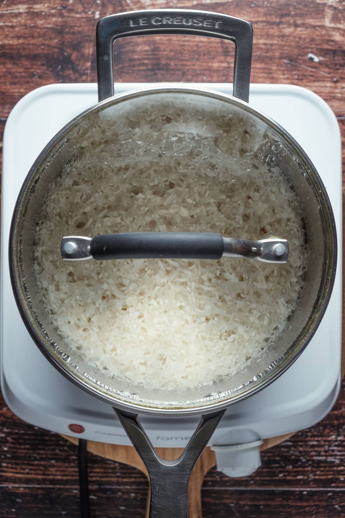 Basmati rice resting in a pot with the lid on.