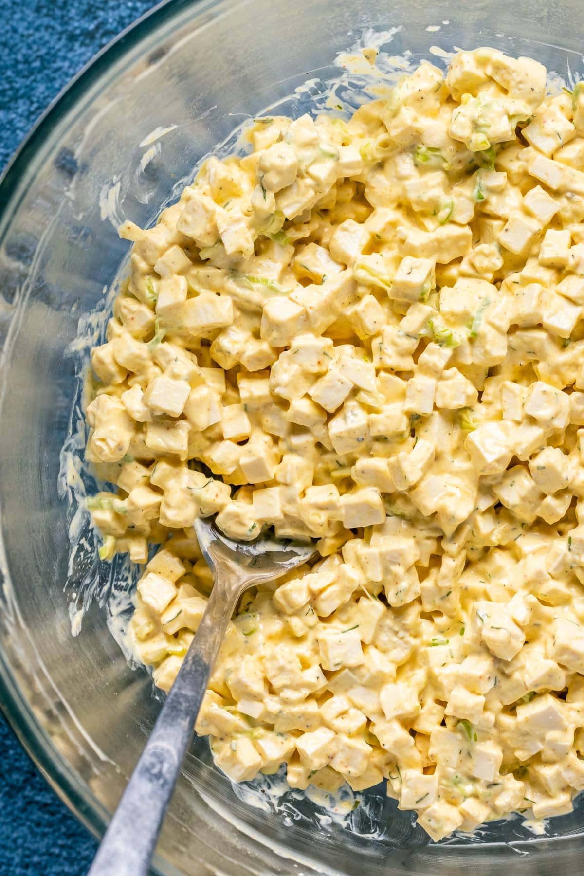 Vegan egg salad in a bowl with a spoon.