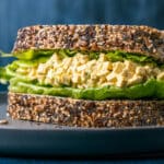 Vegan egg salad on whole wheat bread with lettuce.