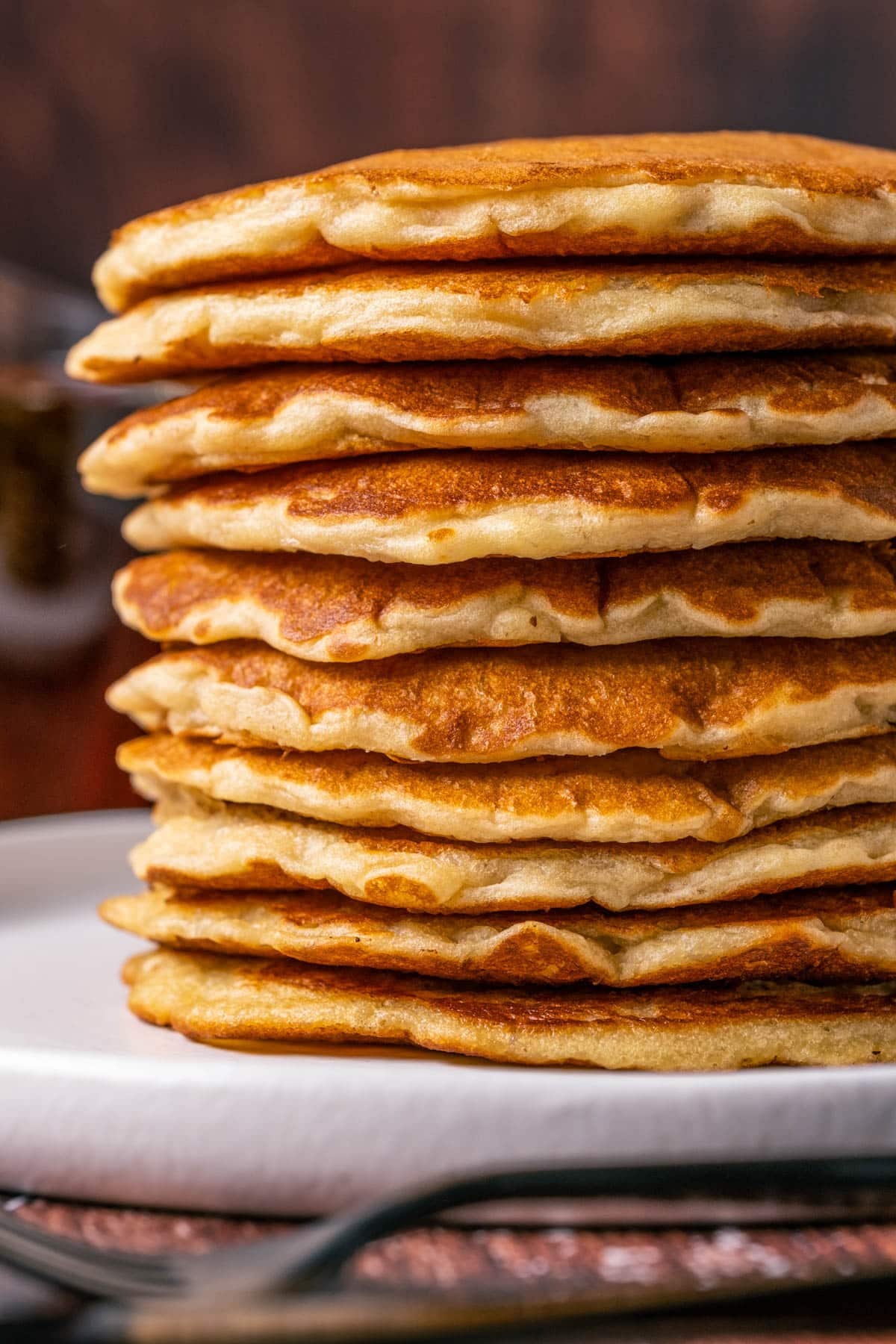Vegan oatmeal pancakes in a stack on a white plate.