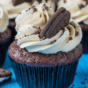 Vegan Oreo cupcakes topped with vanilla frosting and crushed Oreo cookies.