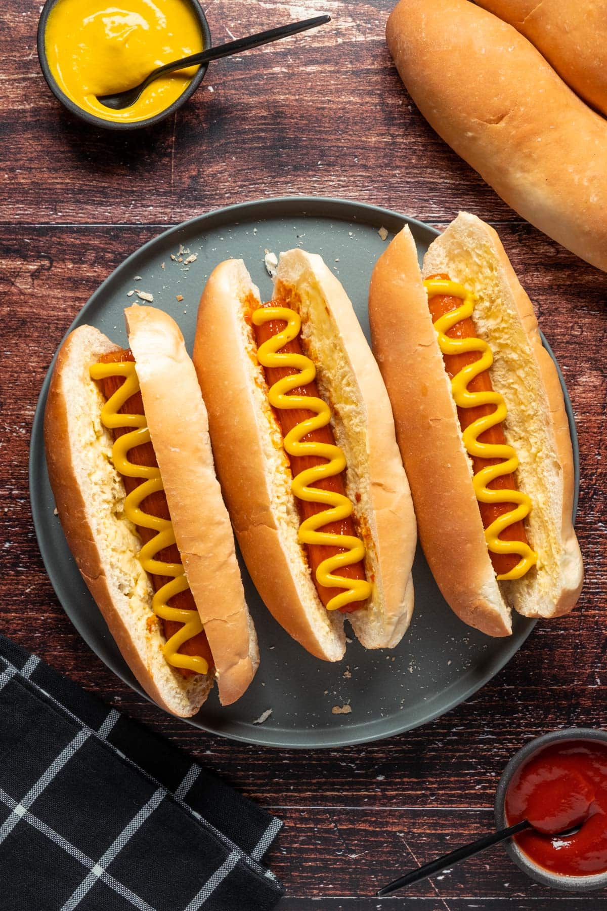 Carrot dogs with mustard on a gray plate. 