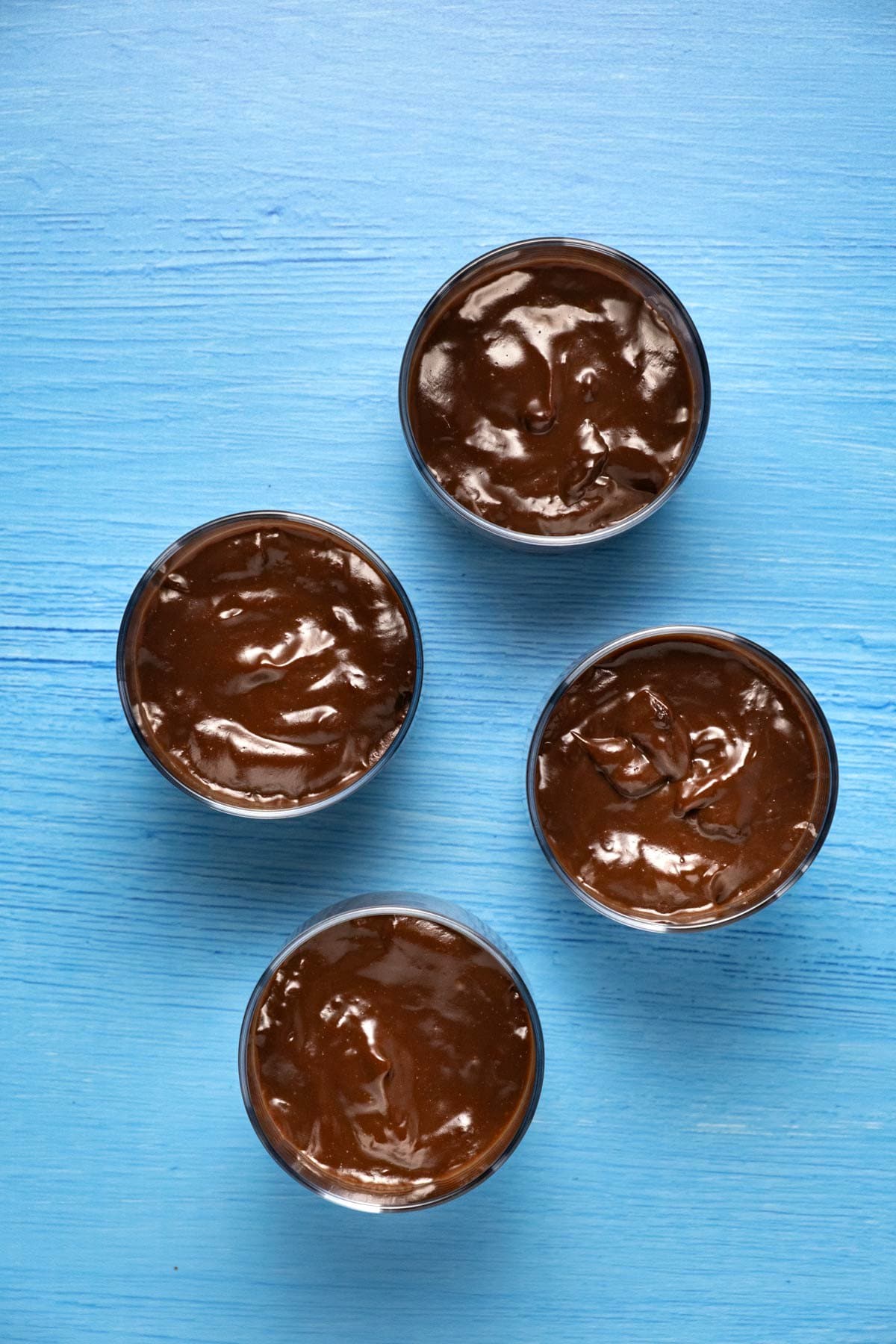 Vegan chocolate pudding in glass ramekins. 