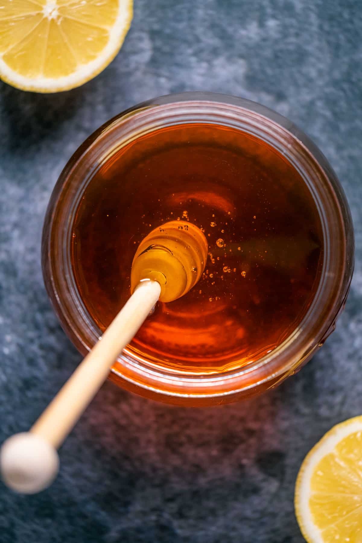 Vegan honey in a jar with a honey dipper.