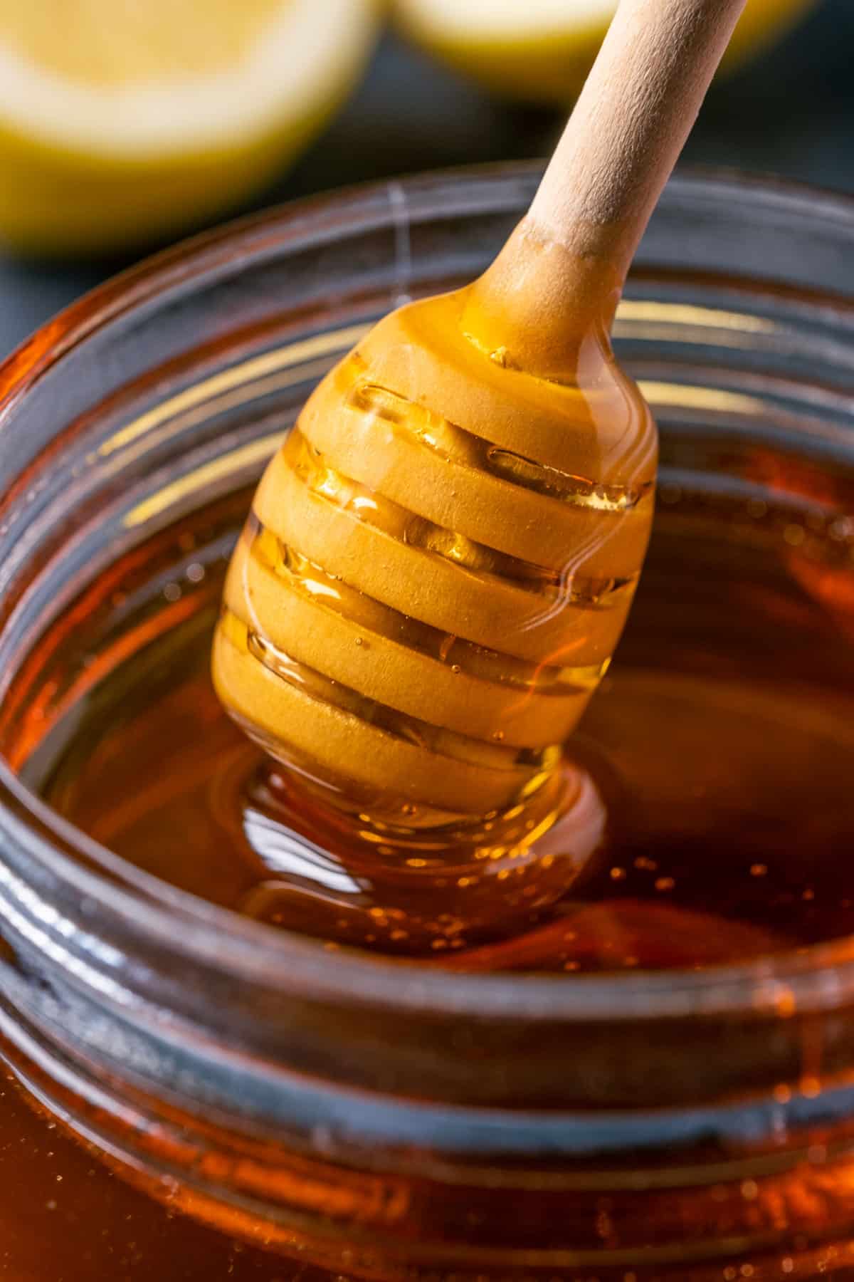 Vegan honey in a jar with a honey dipper.