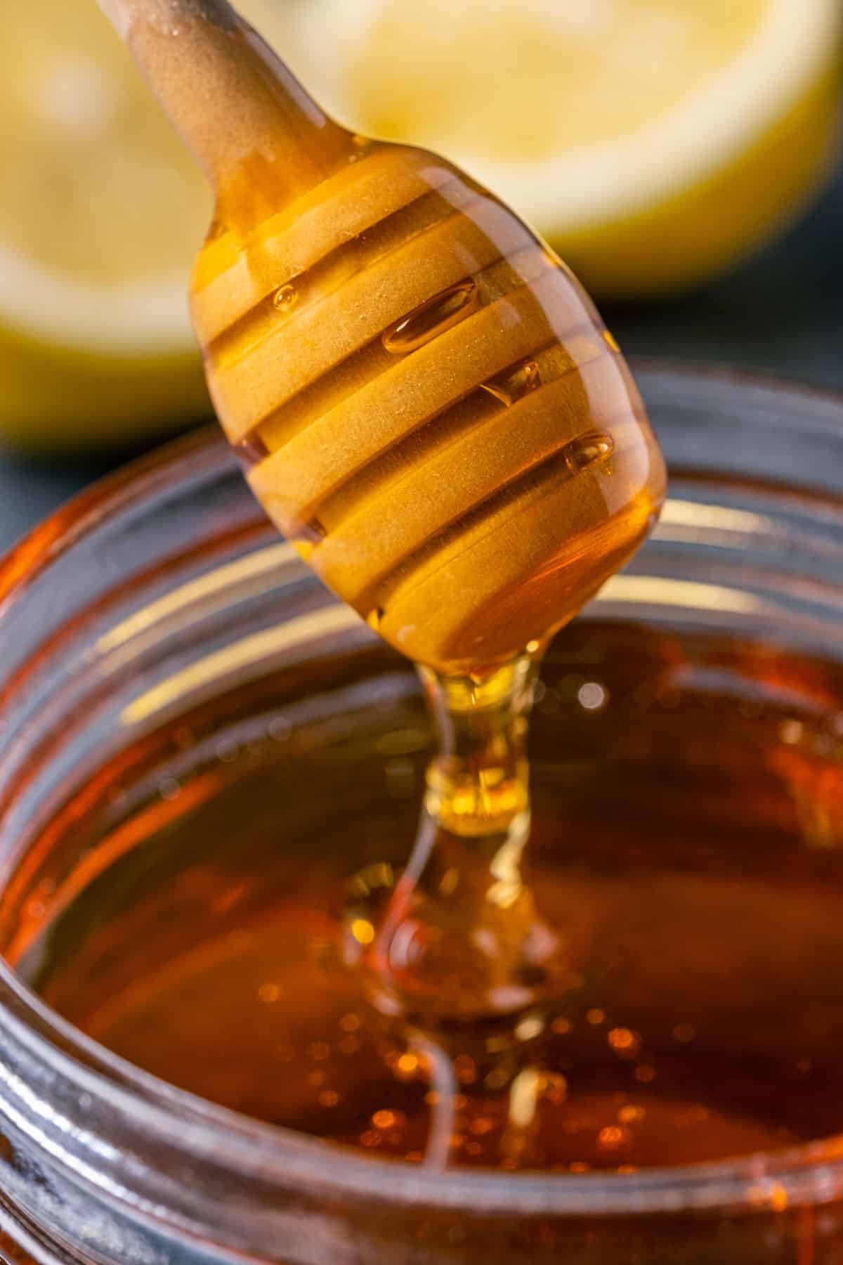 Vegan honey in a jar with a honey dipper. 