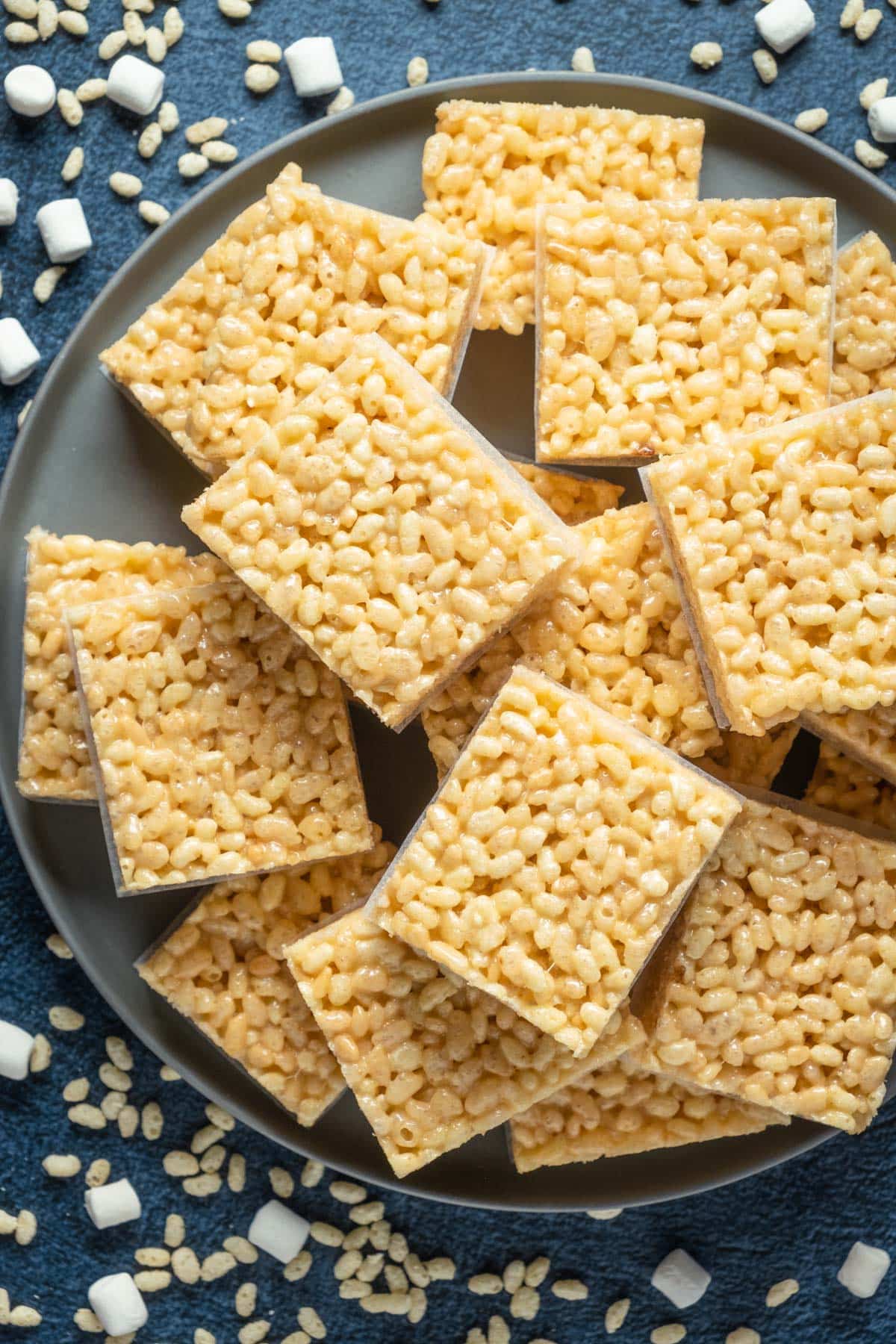 Vegan rice krispie treats stacked up on a gray plate.