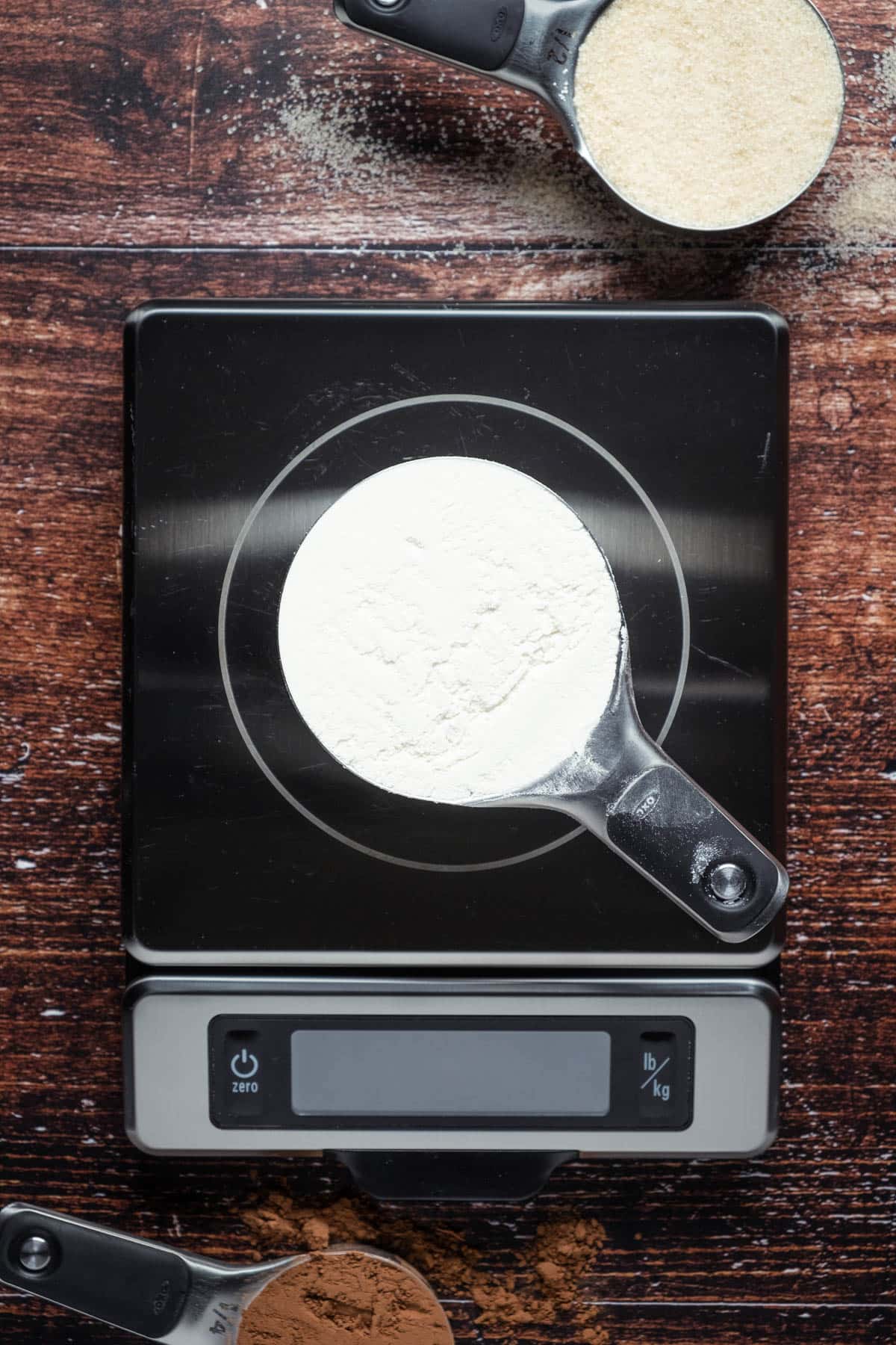 Level cup of flour on a food scale.