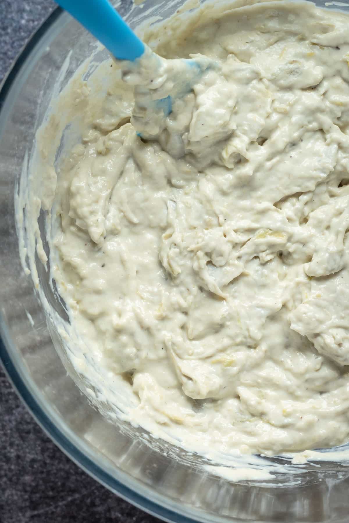Creamy dip in a glass mixing bowl.