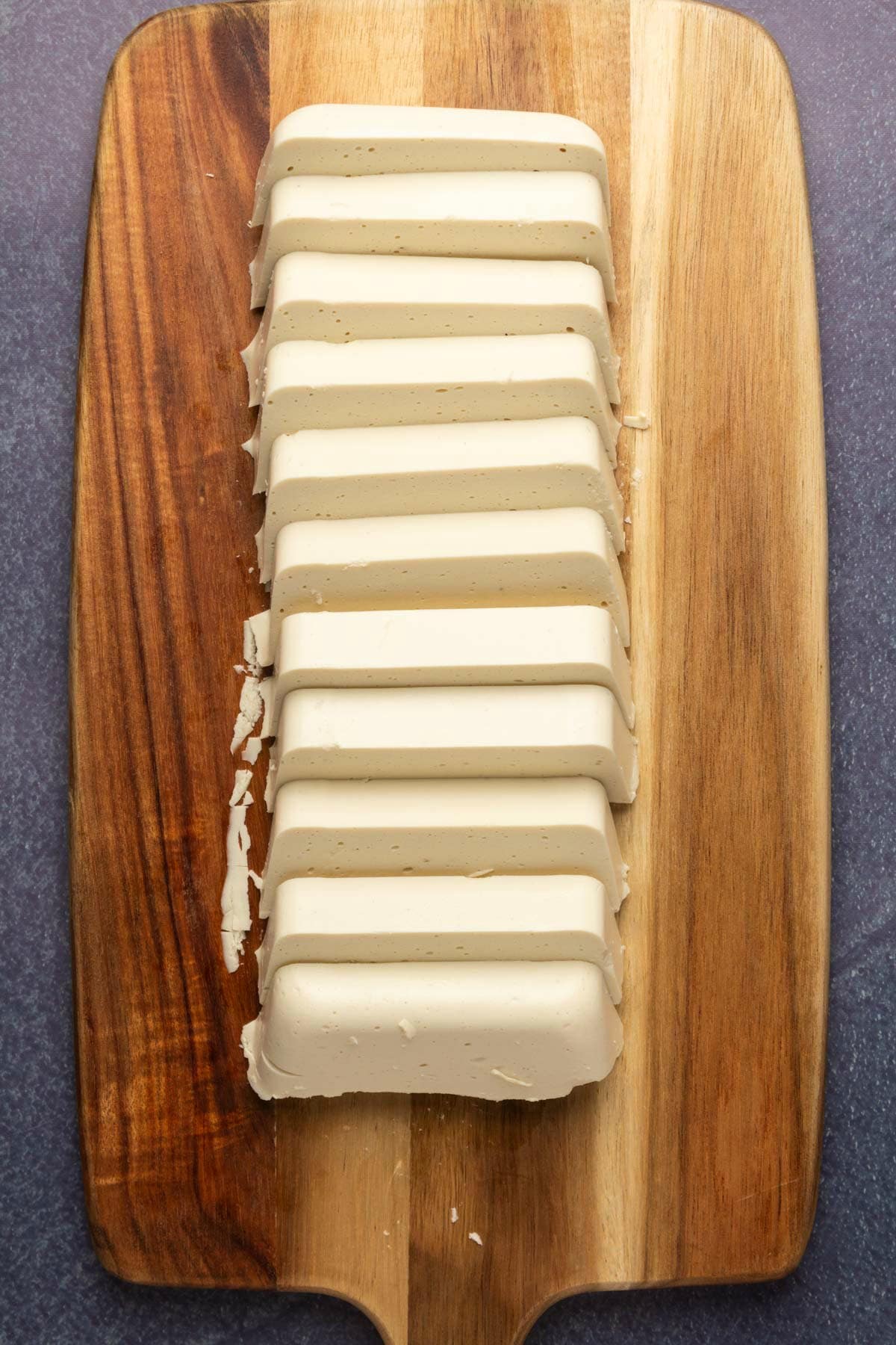 Vegan cheese cut into slices.