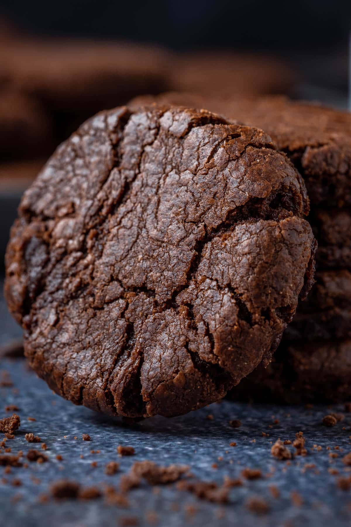 A vegan brownie cookie leaning against a stack of vegan brownie cookies.