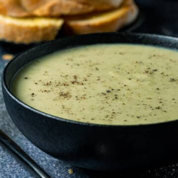 Vegan Potato Broccoli Soup in a black bowl.